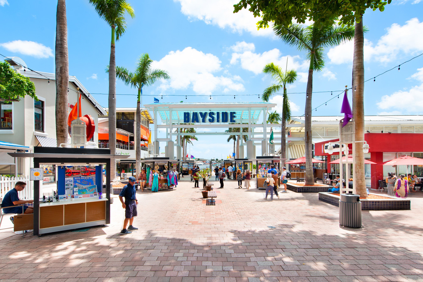 Bayside Marina docks with boats and waterfront dining promenade