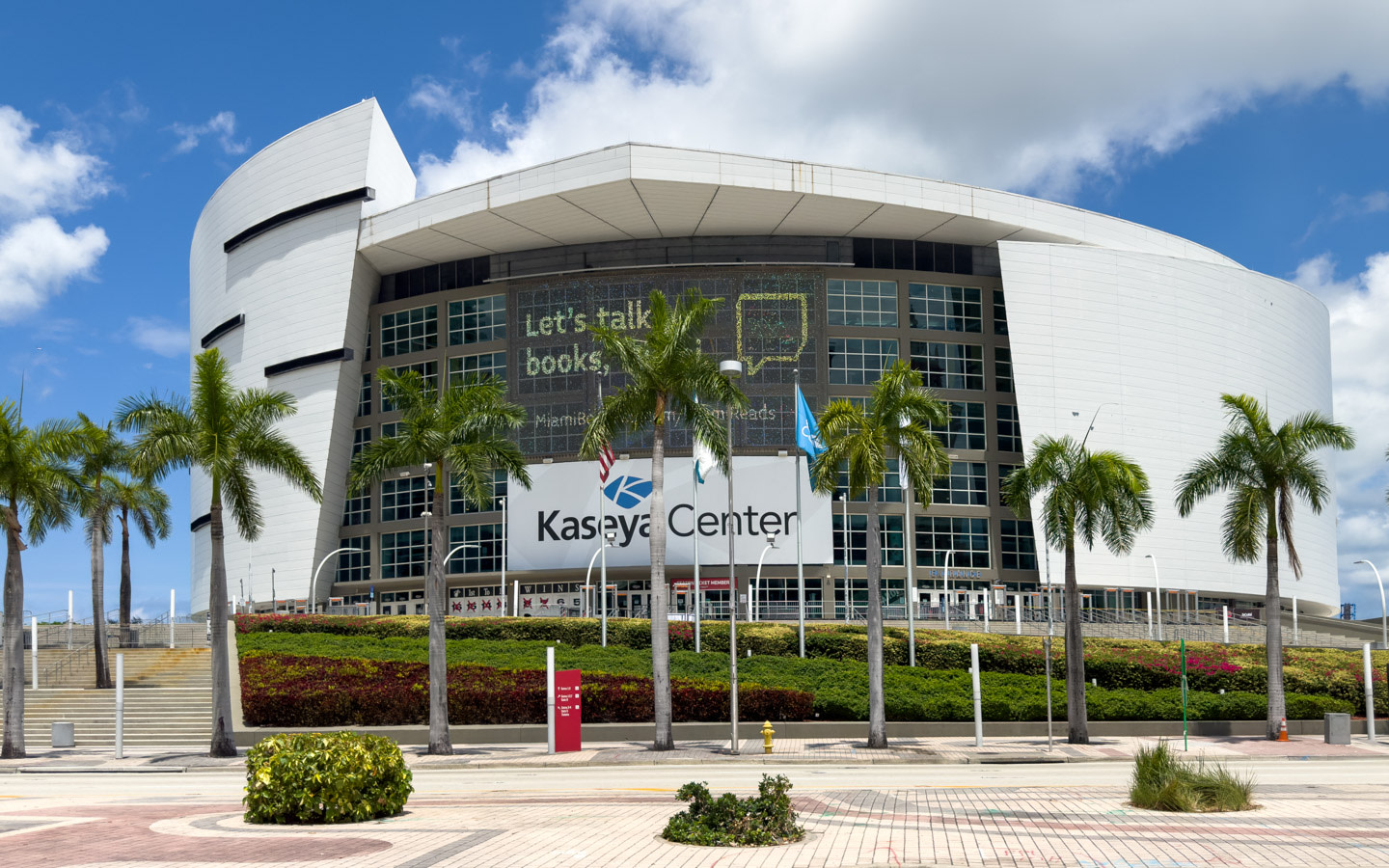 Kaseya Center arena exterior illuminated under blue coastal skies